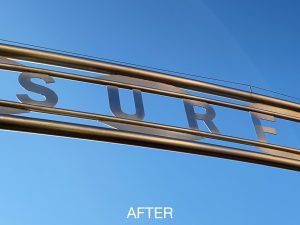 Cleaning outdoor stainless sign, Surfers Paradise sign after